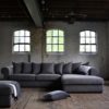 Corner sofa Juliette with loose back cushions and round armrests in a gray fabric