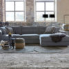 Corner sofa Noelle in a grey-blue fabric with round rugs