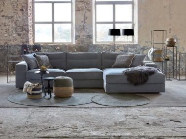 Corner sofa Noelle in a grey-blue fabric with round rugs