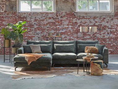 Corner sofa with lumbar cushions in a Hunter green velvet fabric