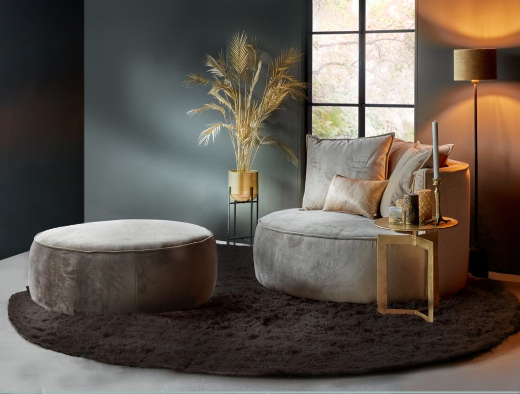 Gray round loveseat with ottoman and golden accessories