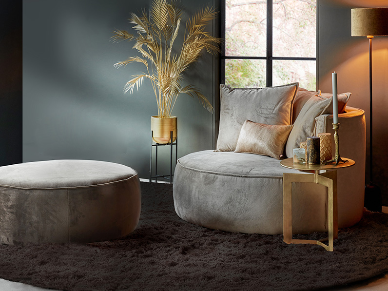 Round gray armchair with golden accessories