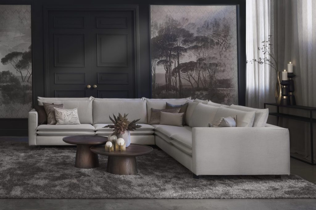 Corner sofa Nadine with double back and seat cushions in a light beige / gray fabric