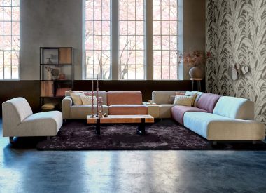 Zona giorno Axelle concepita come un ampio divano ad angolo con un elemento separato. Gli elementi hanno colori e tessuti diversi.
