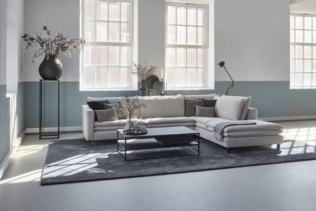 Corner sofa Nadine in light gray with double lumbar cushions.